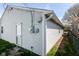 Exterior view of home with vinyl siding, an electrical meter, and partial yard at 1414 Waldemere Ave, Indianapolis, IN 46241