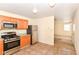 Functional kitchen design featuring stainless steel appliances, granite countertops, and tile flooring, connecting to the living area at 1414 Waldemere Ave, Indianapolis, IN 46241
