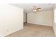 Spacious living room features neutral carpet, a ceiling fan, and ample natural light, ready for personalization and comfort at 1414 Waldemere Ave, Indianapolis, IN 46241