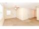 Inviting living room with cozy carpet, a ceiling fan, natural light, and easy access to other areas of the home at 1414 Waldemere Ave, Indianapolis, IN 46241