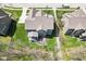 An aerial shot displaying the home's backyard patio, lush greenery, and surrounding landscape at 14413 Arnett Dr, Carmel, IN 46033