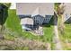 Aerial perspective showcasing a home's backyard with patio, staircase and a well-maintained lawn at 14413 Arnett Dr, Carmel, IN 46033