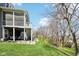 Scenic backyard with a spacious screened porch, a patio, and lush green space at 14413 Arnett Dr, Carmel, IN 46033