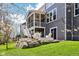 Beautiful backyard featuring a screened porch, patio area, and lush green landscaping at 14413 Arnett Dr, Carmel, IN 46033