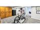 Finished basement featuring a safe, cabinet, and stationary bike set up at 14413 Arnett Dr, Carmel, IN 46033