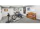 Finished basement with exercise bike, bench and mini-fridge providing ample room for recreation at 14413 Arnett Dr, Carmel, IN 46033