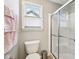Bathroom featuring a white toilet next to the glass shower with sliding doors at 14413 Arnett Dr, Carmel, IN 46033