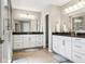 This spacious bathroom features double sinks, white cabinets, and tiled floors at 14413 Arnett Dr, Carmel, IN 46033