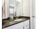 Bathroom vanity features modern fixtures and dark countertop with white cabinets at 14413 Arnett Dr, Carmel, IN 46033
