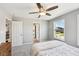 Bedroom with neutral-toned walls and carpet, featuring a ceiling fan and a large window at 14413 Arnett Dr, Carmel, IN 46033