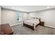 A comfortable bedroom with a large window, bed, and carpet flooring at 14413 Arnett Dr, Carmel, IN 46033
