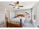 This carpeted bedroom features wood furniture, two windows, and gray paint at 14413 Arnett Dr, Carmel, IN 46033