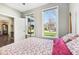 Bright bedroom with large windows offering outside views and access to en-suite bathroom at 14413 Arnett Dr, Carmel, IN 46033