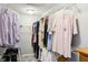 This walk-in closet has hanging racks for clothes and carpeted floors at 14413 Arnett Dr, Carmel, IN 46033
