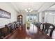 Formal dining room with a large wooden table, elegant chandelier, and a bright window view at 14413 Arnett Dr, Carmel, IN 46033