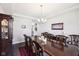 Formal dining room features a long wooden table, elegant chandelier, and classic decor at 14413 Arnett Dr, Carmel, IN 46033