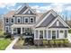 Charming two-story home with a welcoming front porch and beautifully landscaped front yard at 14413 Arnett Dr, Carmel, IN 46033