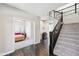 Bright foyer features hardwood floors, a staircase with iron railings, and a view into the bedroom at 14413 Arnett Dr, Carmel, IN 46033