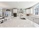Open kitchen features white cabinets, stainless steel appliances, and a large island with countertop seating at 14413 Arnett Dr, Carmel, IN 46033