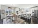 Open-concept kitchen and dining area with modern decor, stainless steel appliances, and abundant natural light at 14413 Arnett Dr, Carmel, IN 46033