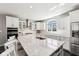 Bright kitchen features white cabinets, stainless steel appliances, and a large center island with a sink at 14413 Arnett Dr, Carmel, IN 46033