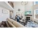 Elegant living room featuring a fireplace, high ceilings, and an open floor plan at 14413 Arnett Dr, Carmel, IN 46033