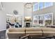 Bright living room featuring a fireplace, large windows, and a comfortable seating area at 14413 Arnett Dr, Carmel, IN 46033