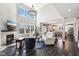 Open-concept living room showcasing a fireplace, hardwood floors, and easy access to the kitchen at 14413 Arnett Dr, Carmel, IN 46033