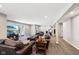 Spacious living room with plush leather seating and access to a walkout patio at 14413 Arnett Dr, Carmel, IN 46033
