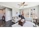 Comfortable living room with a ceiling fan, plush seating, and natural light from the windows at 14413 Arnett Dr, Carmel, IN 46033