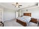 This carpeted bedroom features a ceiling fan, gray paint, and wood furniture at 14413 Arnett Dr, Carmel, IN 46033