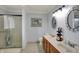 Bathroom with a double sink vanity, decorative mirrors, walk-in shower and a tiled floor at 1444 Trail Creek Ct, Carmel, IN 46032