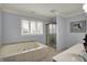 Bright bathroom featuring a soaking tub, separate shower, and large window for ample light at 1444 Trail Creek Ct, Carmel, IN 46032