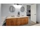 Bathroom featuring a double vanity with two decorative mirrors, a toilet, and views into the bedroom at 1444 Trail Creek Ct, Carmel, IN 46032