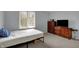 Bedroom featuring a single bed, a dresser with a TV and window with views of the neighborhood at 1444 Trail Creek Ct, Carmel, IN 46032
