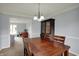 Cozy dining room featuring a wood table, chairs, stylish chandelier, and view into the living room at 1444 Trail Creek Ct, Carmel, IN 46032