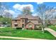 Beautiful brick home boasts a meticulously maintained lawn and charming architectural details at 1444 Trail Creek Ct, Carmel, IN 46032
