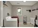 A laundry room with a white washer and red dryer with a window to let in natural light at 1444 Trail Creek Ct, Carmel, IN 46032