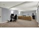 Finished basement with modern ceiling, carpeted floors, and a comfortable seating area at 1444 Trail Creek Ct, Carmel, IN 46032