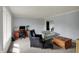 Inviting living room features neutral carpeting, blue walls, and comfortable seating around a wooden coffee table at 1444 Trail Creek Ct, Carmel, IN 46032