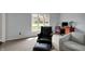 Comfortable living room with neutral carpeting, soft blue walls, and large window for natural light and view at 1444 Trail Creek Ct, Carmel, IN 46032
