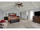 A spacious main bedroom features high vaulted ceilings, a seating area, and dual closets at 1444 Trail Creek Ct, Carmel, IN 46032