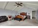 Spacious main bedroom with vaulted ceiling, ceiling fan, seating area, and ensuite bathroom at 1444 Trail Creek Ct, Carmel, IN 46032