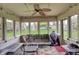 Enclosed sunroom with multiple windows, ceiling fan, and patio furniture, providing a cozy and bright living space at 1444 Trail Creek Ct, Carmel, IN 46032