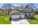 Well-maintained two-story home with a three-car garage, complemented by a spacious yard with mature trees at 15385 Ellington Dr, Fishers, IN 46040