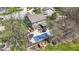 Aerial perspective capturing the backyard swimming pool, deck, and playground, surrounded by mature trees at 15385 Ellington Dr, Fishers, IN 46040