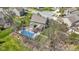 Drone shot showcasing the property's spacious backyard with a pool, deck, and play area in a residential neighborhood at 15385 Ellington Dr, Fishers, IN 46040