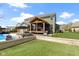 View of an inviting backyard with a pool, deck, and well-manicured lawn, perfect for outdoor entertaining at 15385 Ellington Dr, Fishers, IN 46040
