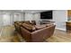 Finished basement space with large leather couch, TV and accent lighting at 15385 Ellington Dr, Fishers, IN 46040