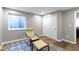 Finished basement space with chair, ottoman, closet, and a patterned area rug at 15385 Ellington Dr, Fishers, IN 46040